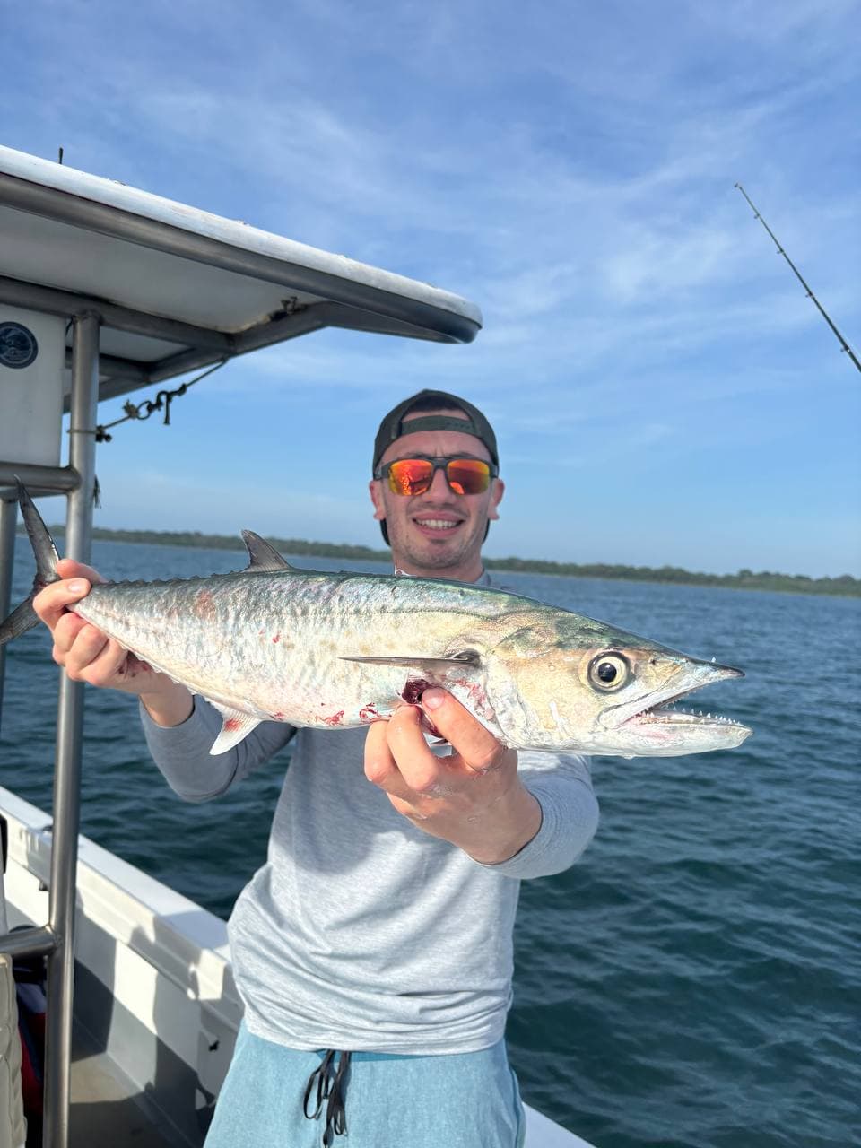 Angler holding a King mackerel on the Caribbean